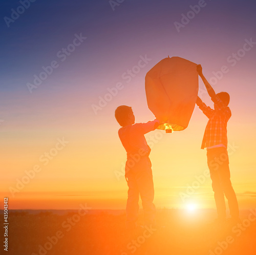 Boys are launching a balloon in nature