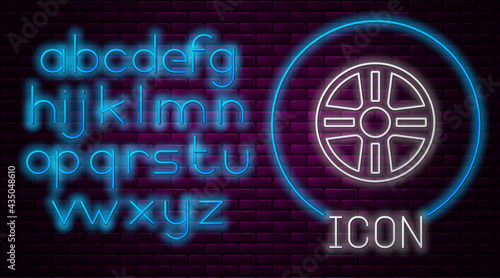 Glowing neon line Alloy wheel for a car icon isolated on brick wall background. Neon light alphabet. Vector