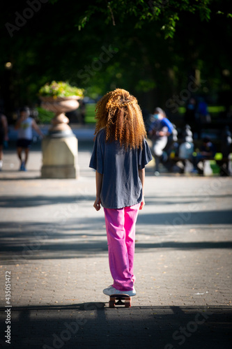 young girl skateboarding on Central Park, New York