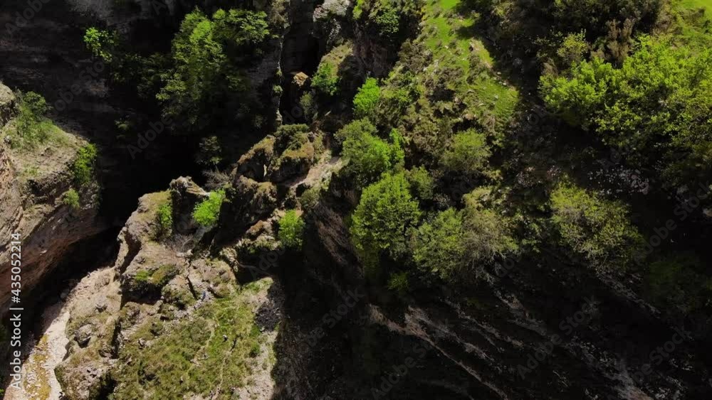 A beautiful aerial view flying down Potato River Falls over the upper cascades, rocks and waterfall with green tree A beautiful aerial view flying down Potato River Falls over the upper cascades, rocks and waterfall with green tree