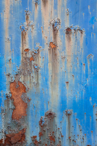 Rust and peeling blue paint.