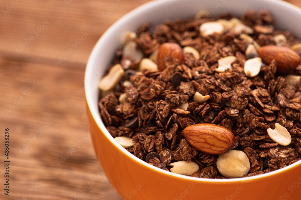 Chocolate granola with almond, nuts in a bowl Chocolate granola with almond, nuts in a bowl