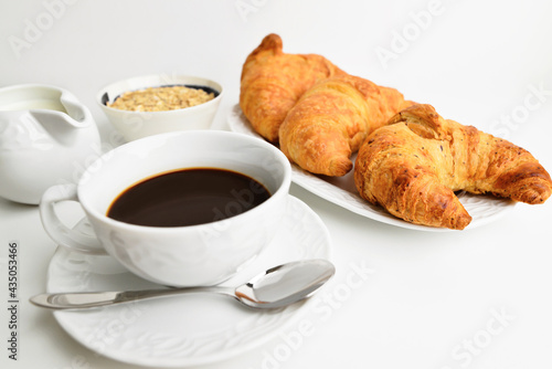 Delicious breakfast background. Tasty croissants, muesli and cofe.