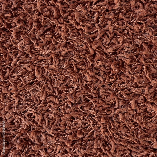 Close up of brown shaggy carpet texture