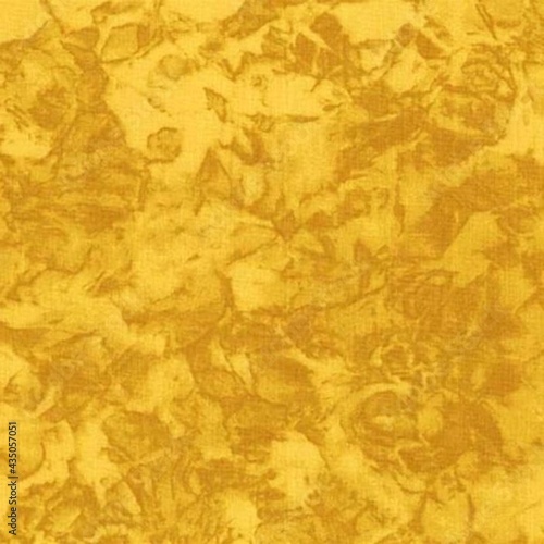 Dyed cotton fabric texture with mottled effect in yellow