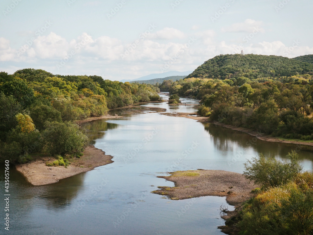 The Ussuri river in summer between green trees on the way from Khabarovsk to Vladivostok The Ussuri river in summer between green trees on the way from Khabarovsk to Vladivostok