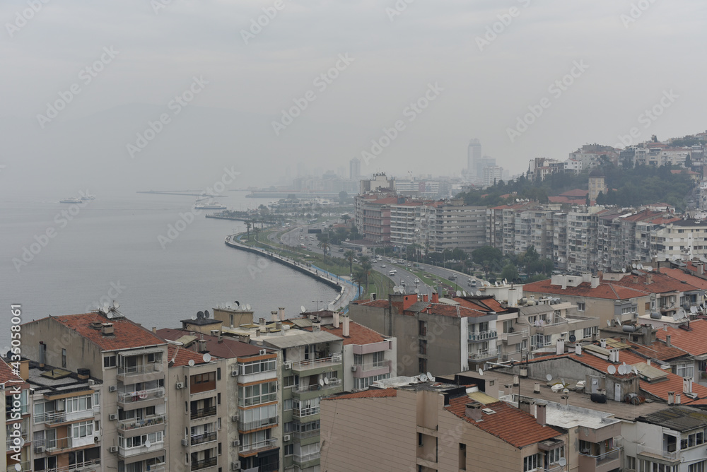 Cityscape of embankment Izmir, Turkey in foggy weather