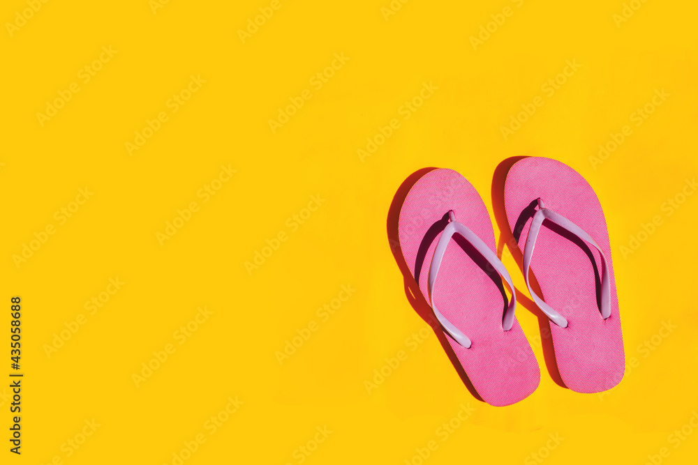 Pink flip flops on bright yellow background. Copy space. Pink flip flops on bright yellow background. Copy space.