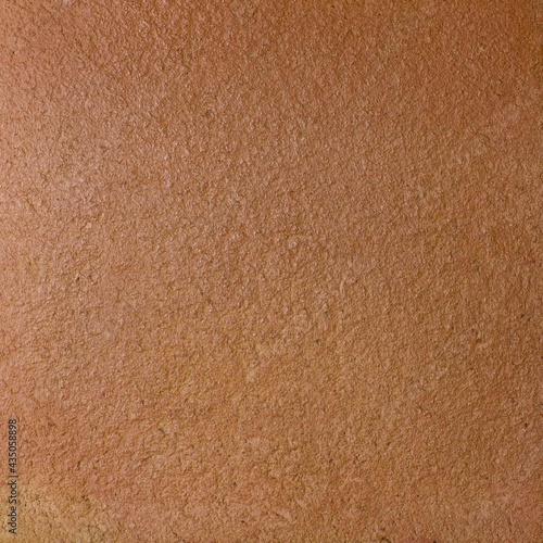 Rough terracotta wall tile with uneven ragged surface
