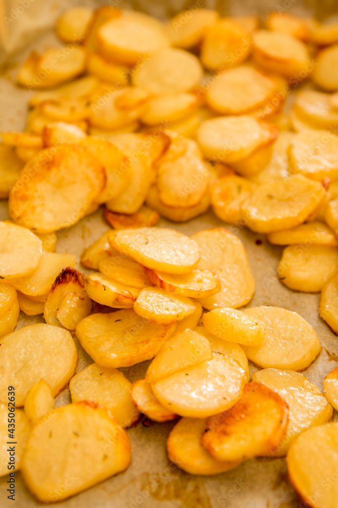 Baked sliced potatoes on a parchment paper - easy appetizer Baked sliced potatoes on a parchment paper - easy appetizer