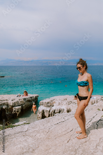 Woman sunbathing and posing at the beach at the ocean