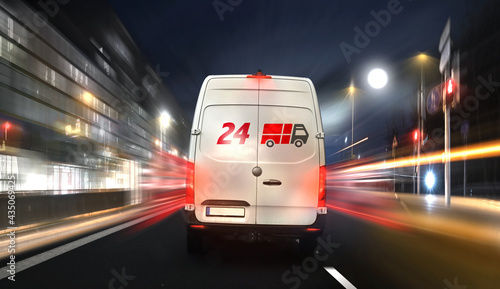 24 hours express delivery van courier service by night in the city on the road fast. 24 hours service. 