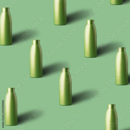 Pattern made with transparent glass bottle with shadow on green pastel backdrop. Minimal summer concept.