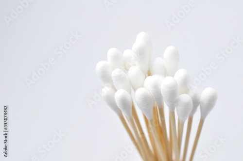 White cotton swabs , cotton buds isolated on white background. wooden handle photo