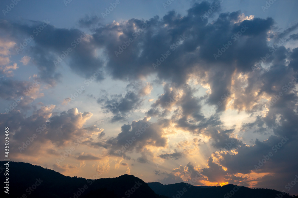 The scenery in the evening sky, the clouds and the sunset, the shadow of the mountains For background