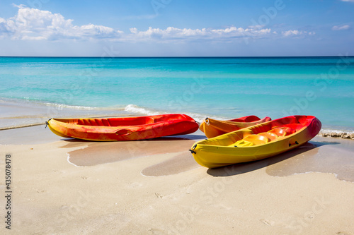 Sea kayaking, canoe, on a tourist resort in Varadero, Cuba. White sand and blue water. photo