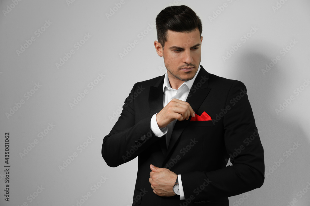 Man with handkerchief in breast pocket of his suit on light background, space for text Man with handkerchief in breast pocket of his suit on light background, space for text