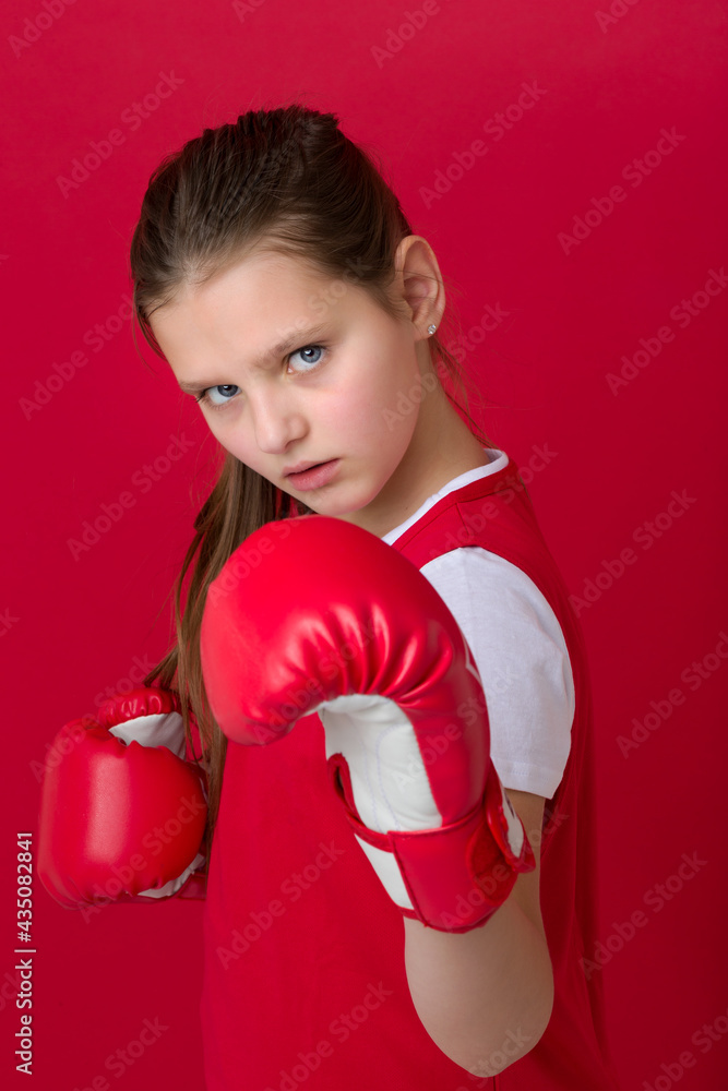Teenage girl posing in boxing gloves