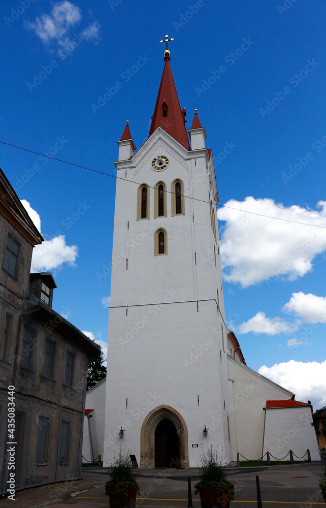 Medieval church of St. John on a background of blue sky with clouds in the old town of Cesis, Latvia