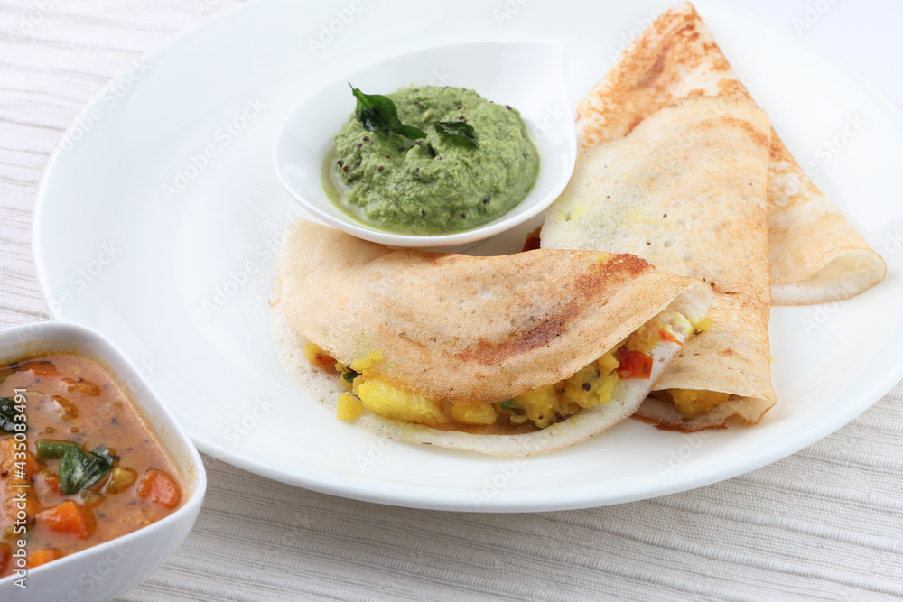 masala dosa with coconut chutney and mint chutney.
South Indian food. masala dosa with coconut chutney and mint chutney.
South Indian food.