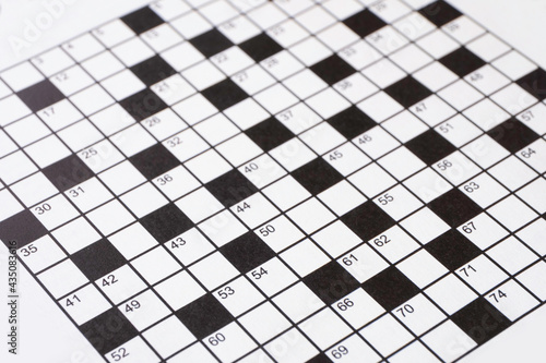 Black and white crossword in a newspaper or magazine. Narrow depth of field photo