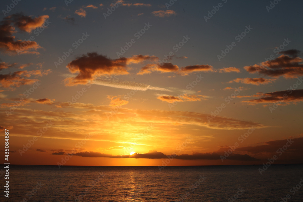 Dramatic sunrise over the Mediterranean sea. orange Cloudy dusk sky and rising sun over water. Beautiful sunshine, stunning sunrise, 
