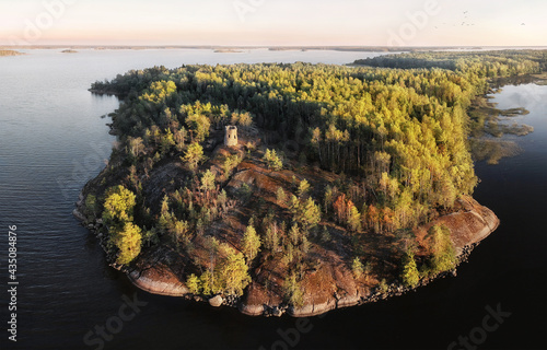 unknown medieval Swedish watchtower at cliff of small uninhabited island. Drone view in Vyborg bay, gulf of Finland.