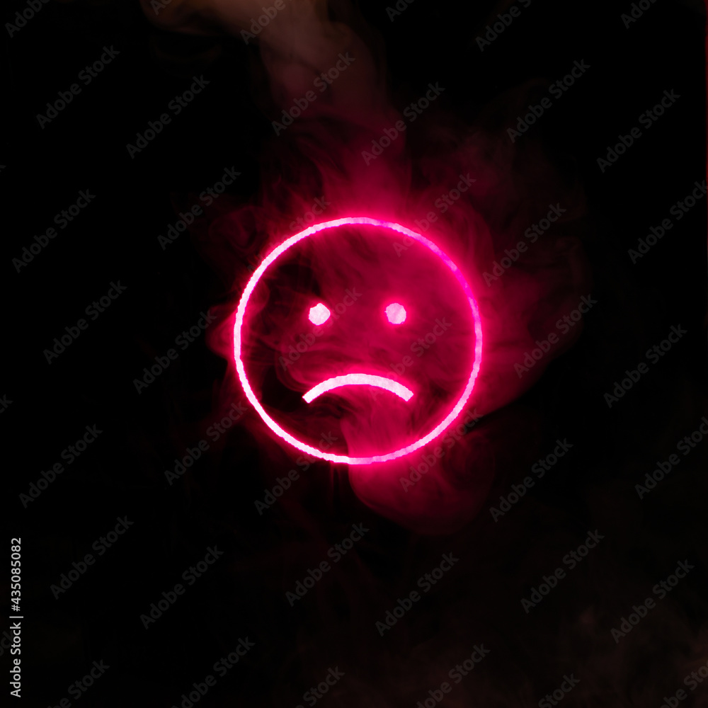 Stylized face expressing emotion glows through the stream of smoke in the dark Stylized face expressing emotion glows through the stream of smoke in the dark
