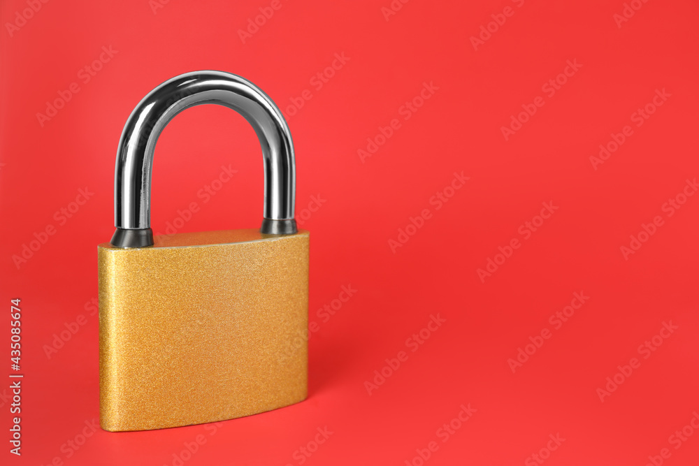Modern padlock on red background. Space for text Modern padlock on red background. Space for text