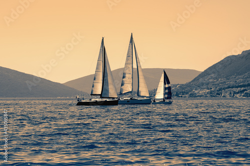 Sailing boats on the water. Mediterranean landscape. Montenegro. Color toning