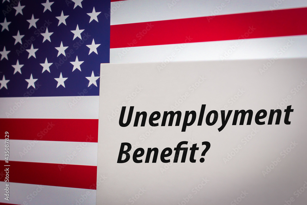 Conceptual keyword Unemployment Benefit? on card on US flag background. Business, economy, social concept of America. Unemployment benefits are payments made by authorized bodies to unemployed people