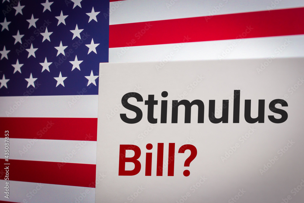Conceptual keyword Stimulus Bill? on card on US flag background. Business, economy, social concept of America. A stimulus bill is a government program provides economic stimulus Conceptual keyword Stimulus Bill? on card on US flag background. Business, economy, social concept of America. A stimulus bill is a government program provides economic stimulus