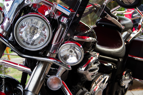 A close up shot of a red, black and chrome motorcycle
