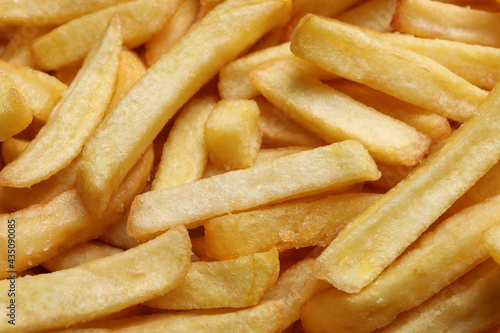 Yummy French fries as background, closeup view