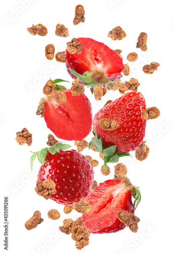 Delicious granola and strawberries falling on white background. Healthy snack