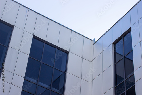 Modern office building against the sky. Facade of a business building. Office building windows.