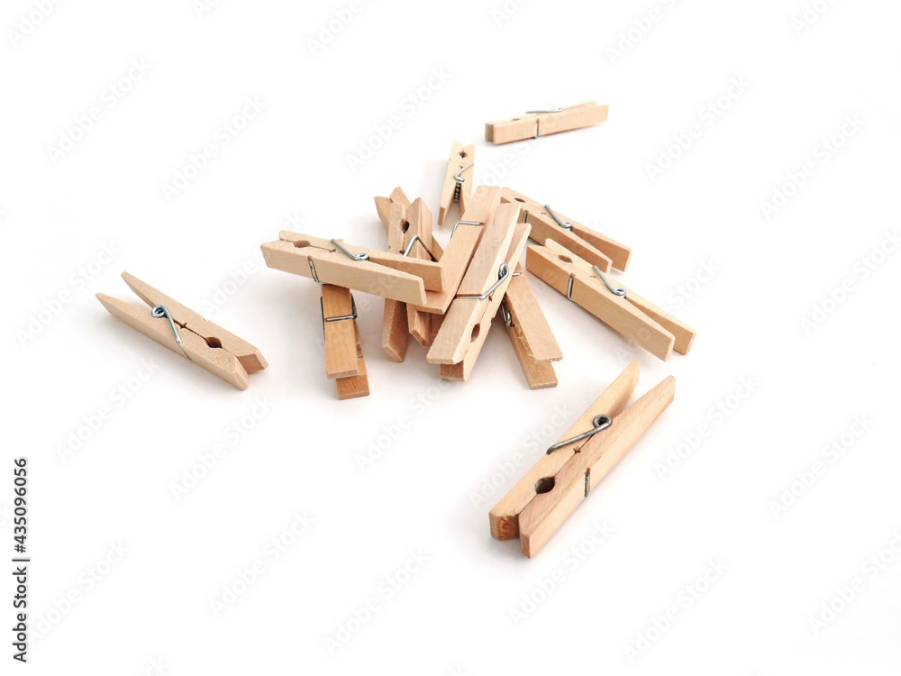 Set of wooden clothespins on white background. Close up of Pile of small wooden clip. Home accessories. Set of wooden clothespins on white background. Close up of Pile of small wooden clip. Home accessories.