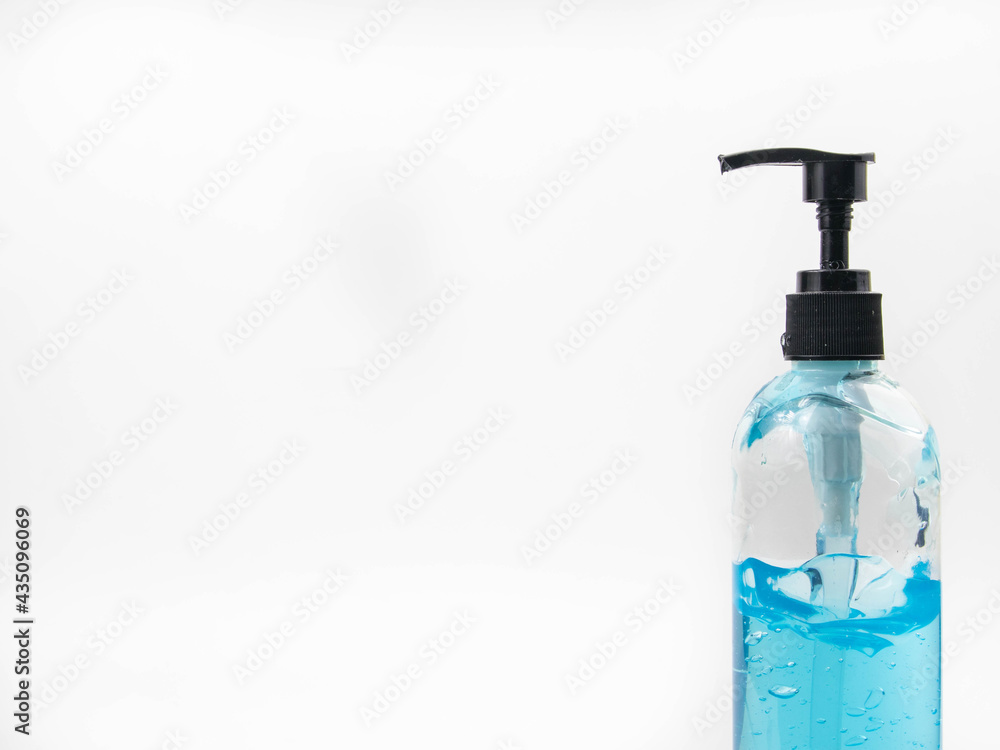 Clear plastic bottle The top of the bottle is a pump head, containing clear blue alcohol Take a picture on a white background Clear plastic bottle The top of the bottle is a pump head, containing clear blue alcohol Take a picture on a white background