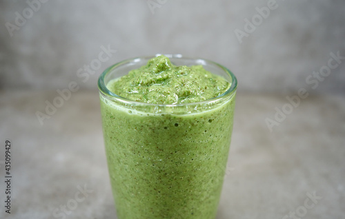 Green vegetable smoothie in the galss