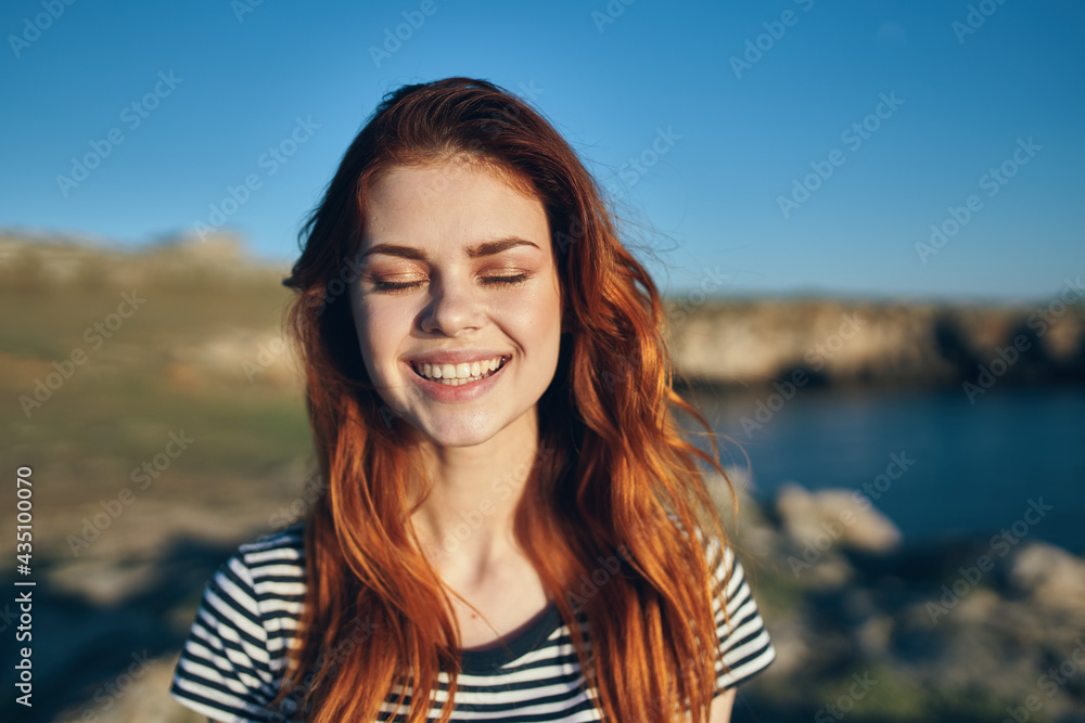 happy woman in the mountains on the beach near the lake vacation relax smile model happy woman in the mountains on the beach near the lake vacation relax smile model
