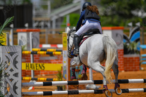 Rider on horse jumping over a hurdle during the equestrian event 