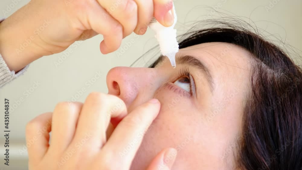 Young woman putting eye drops. Young woman putting eye drops.