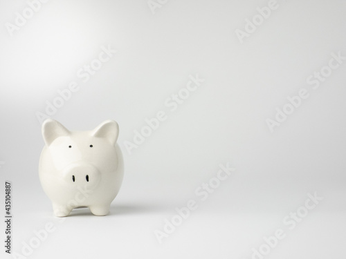 Piggy bank in white background minimal style, Business, finance, investment, saving and corruption concept.	