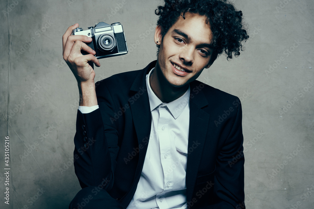 guy holding a camera in his hand retro classic suit curly model man guy holding a camera in his hand retro classic suit curly model man