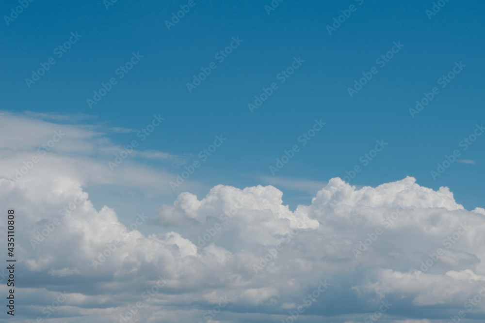 Aerial view on moody thunder clouds flying on horizon under blue sky Aerial view on moody thunder clouds flying on horizon under blue sky