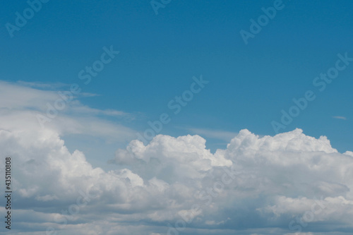 Aerial view on moody thunder clouds flying on horizon under blue sky 