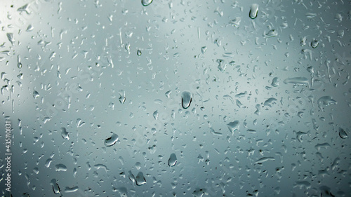 raindrops on a glass window on the background of an aluminum wall, backgrounds, textures