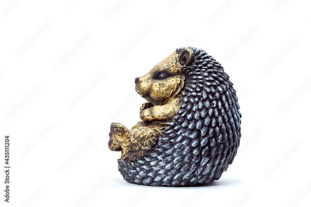 Obraz premium artificial concrete garden figure for landscaping and backyard decoration, isolated sedentary hedgehog side view on a white background, nobody.