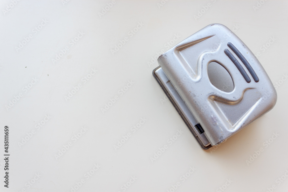 close up of a paper punch on a white background close up of a paper punch on a white background