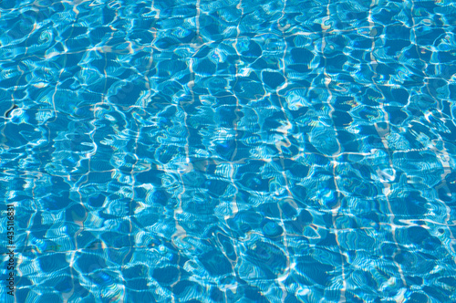 Shining blue water ripple background. sun reflection background ripple water. swimming pool water. surface of blue swimming pool background of water in swimming pool © Евгения Иванова